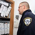 שוטר אוסף מסמכים בעירייה צילום: עופר עמרם