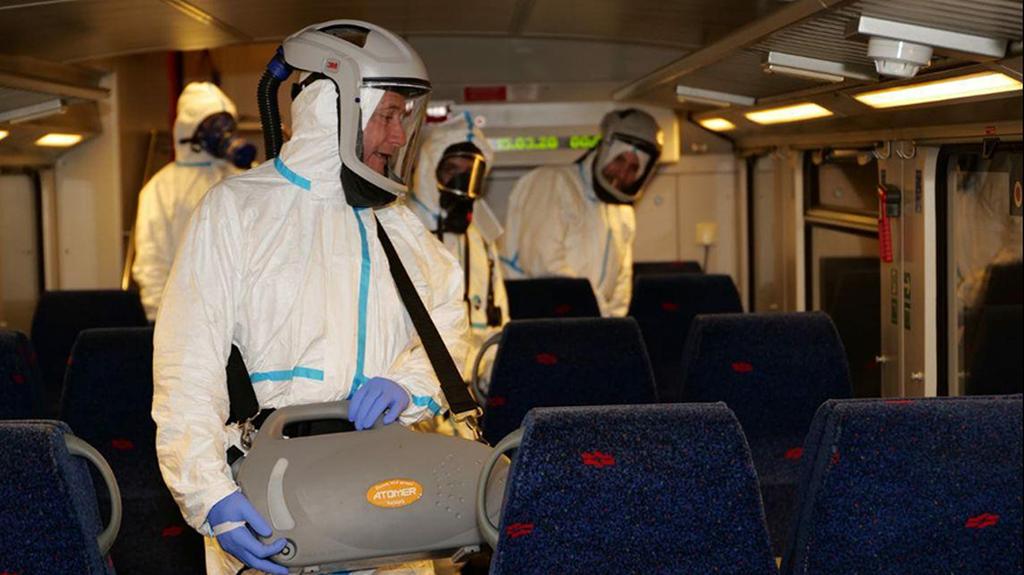 Health workers disinfecting a train wagon  ()